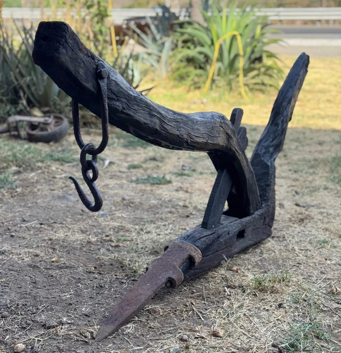 Old and original wooden plow with a share