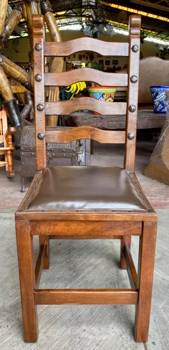 Antique handcrafted chair made of mesquite wood and leather.