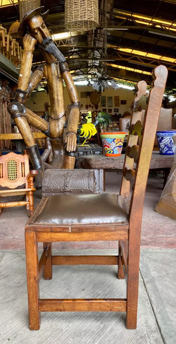 Antique handcrafted chair made of mesquite wood and leather.