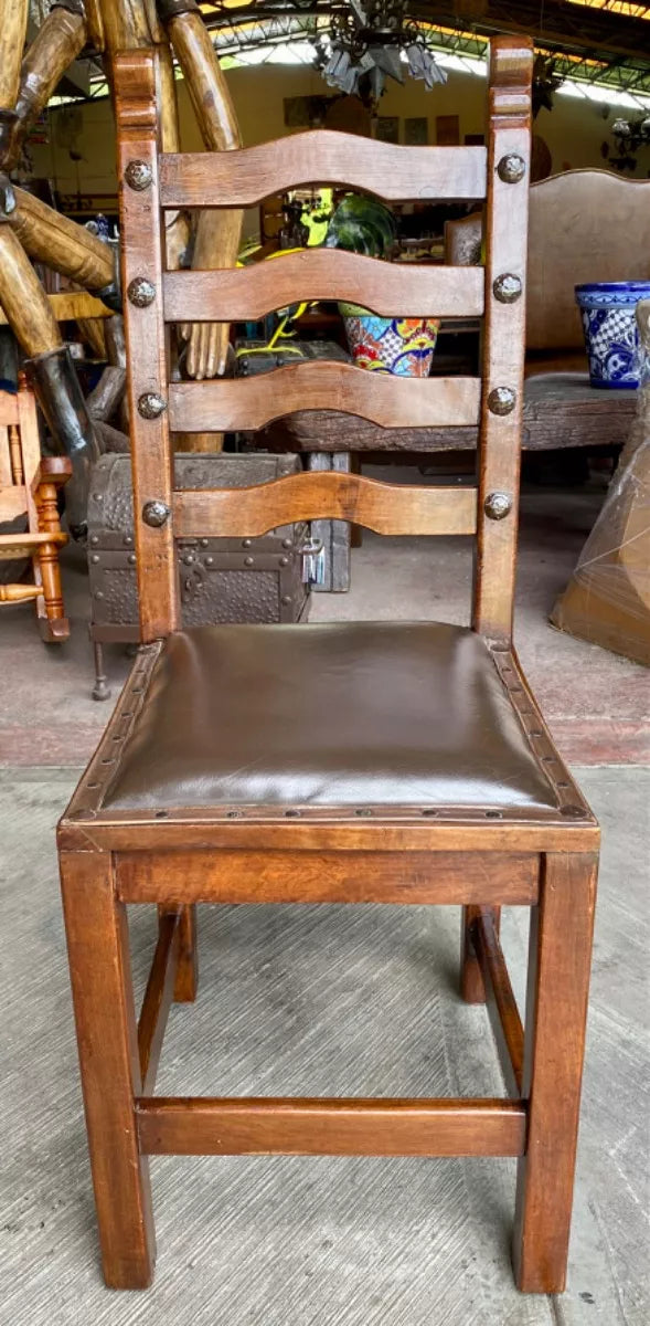 Antique handcrafted chair made of mesquite wood and leather.
