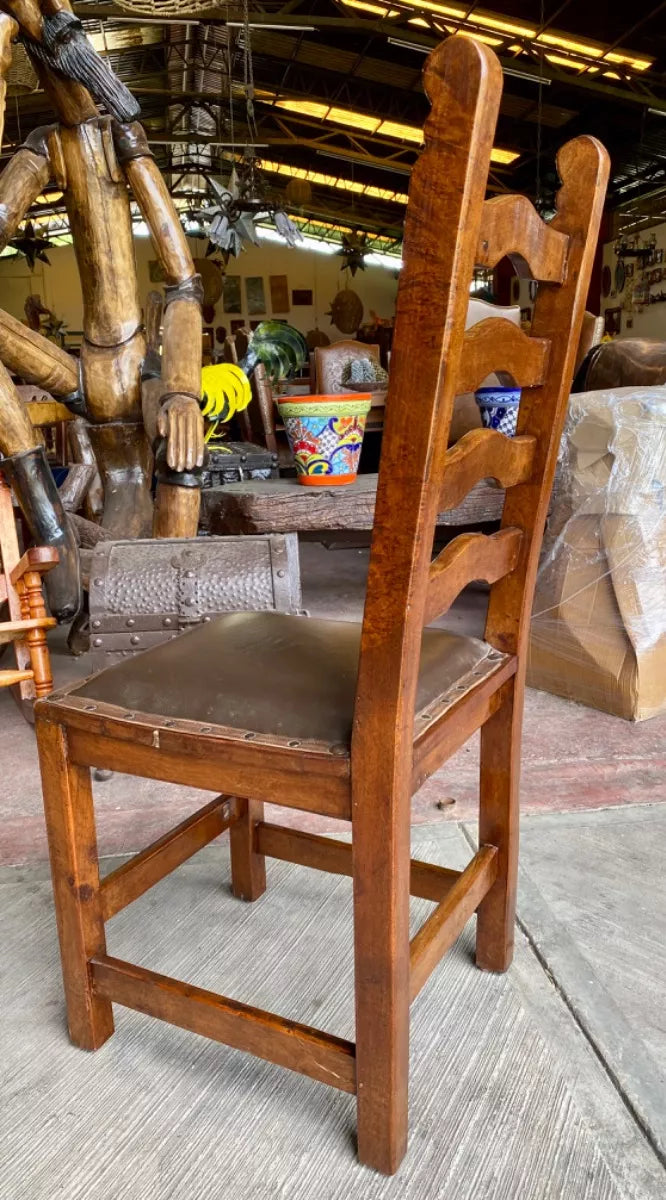Antique handcrafted chair made of mesquite wood and leather.