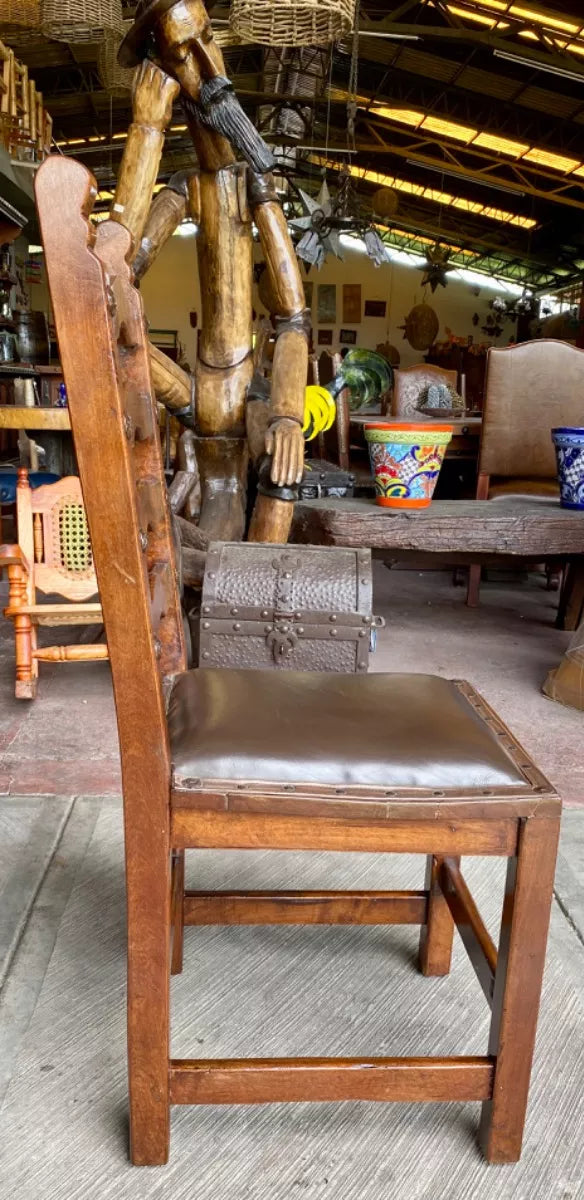 Antique handcrafted chair made of mesquite wood and leather.