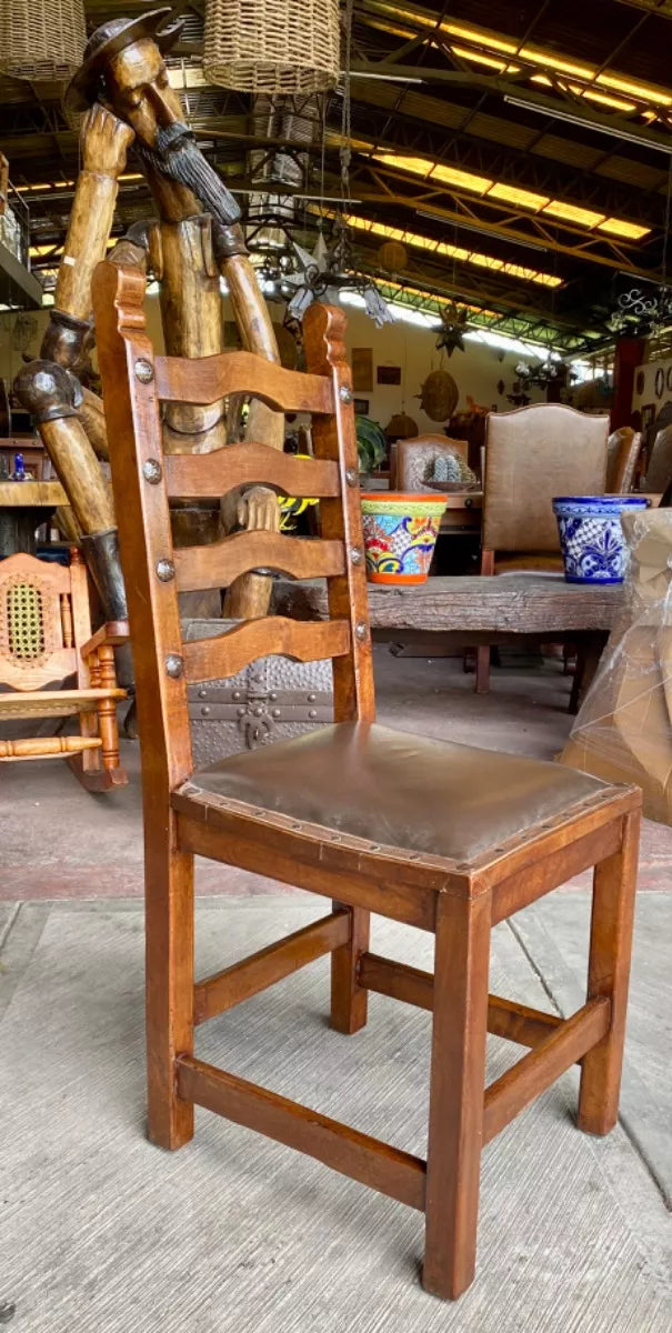 Antique handcrafted chair made of mesquite wood and leather.