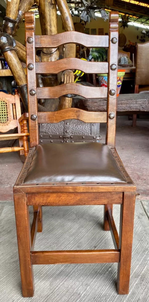 Antique handcrafted chair made of mesquite wood and leather.