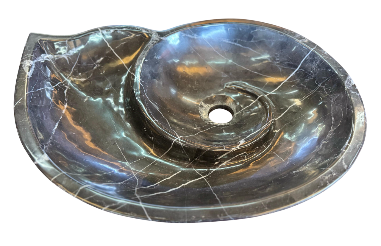 Black marble sink in the shape of a snail fossil