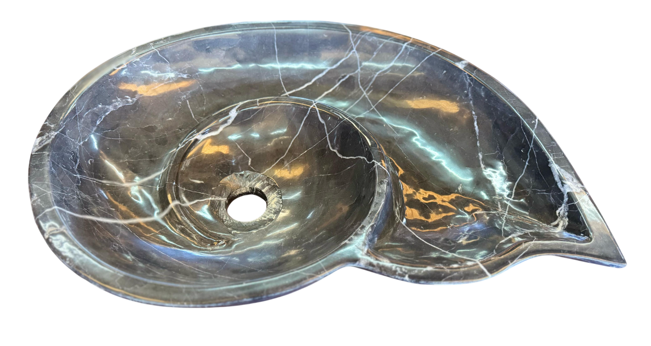 Black marble sink in the shape of a snail fossil