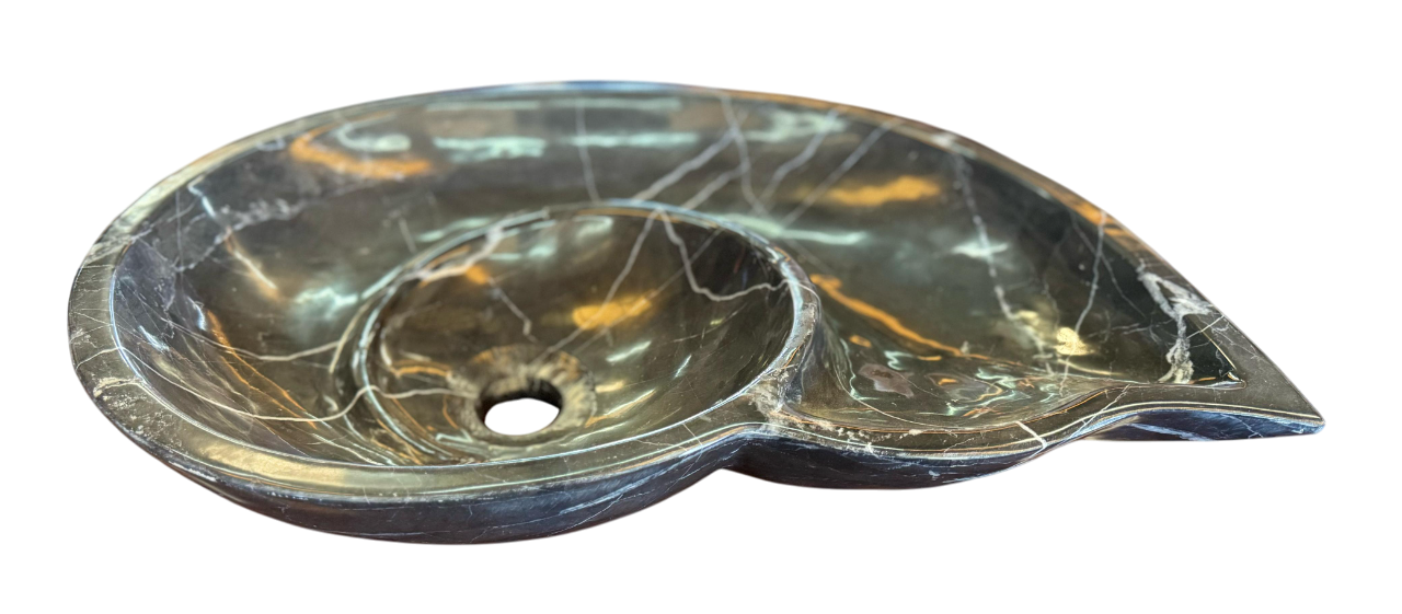 Black marble sink in the shape of a snail fossil