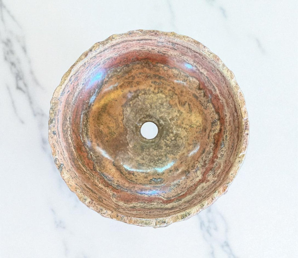 Round countertop sink in fine antique-style marble.