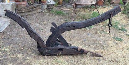 Old and original wooden plow with a share