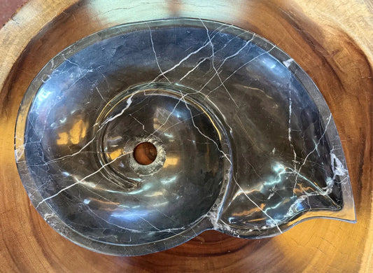 Snail-shaped countertop sink in fine antique-style marble.