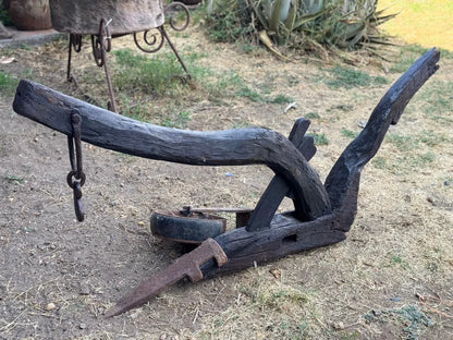Old and original wooden plow with a share